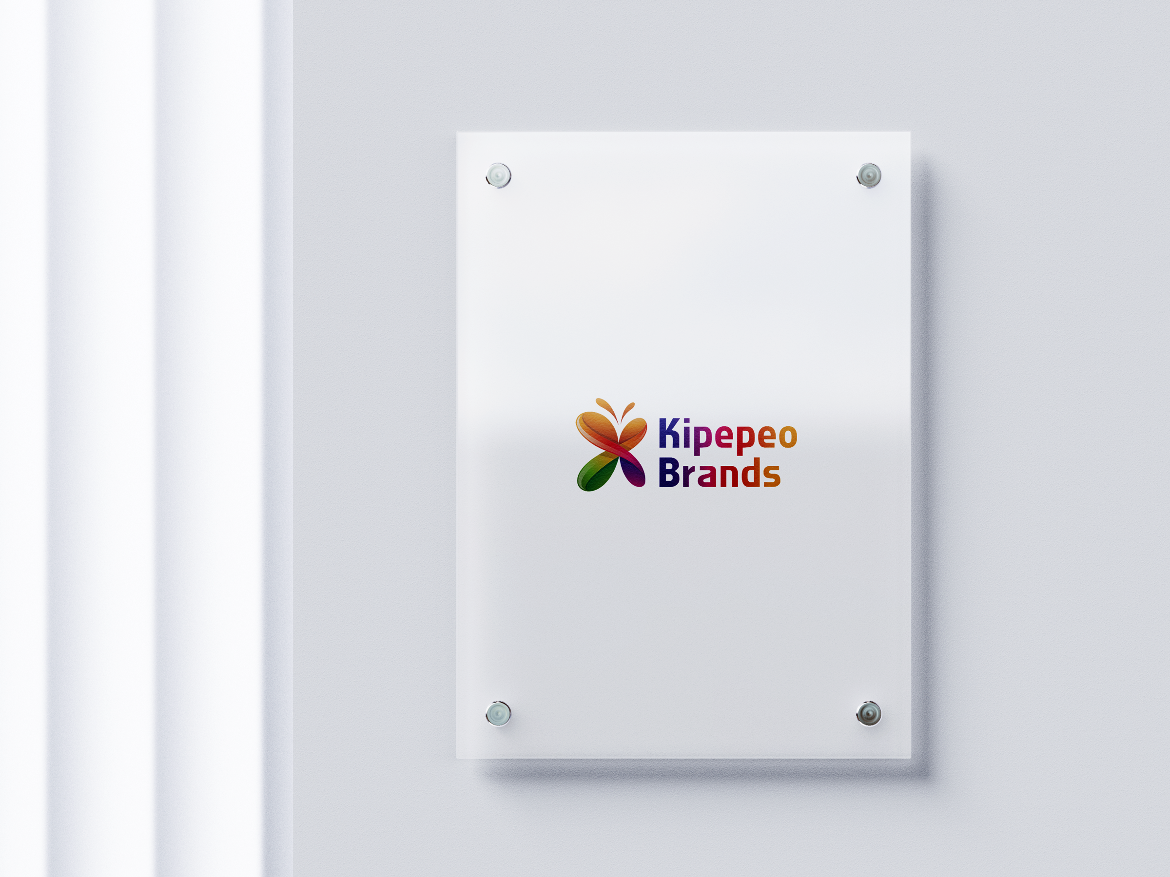 Modern Perspex signage with Kipepeo Brands logo on a sleek acrylic plaque mounted on a white wall.